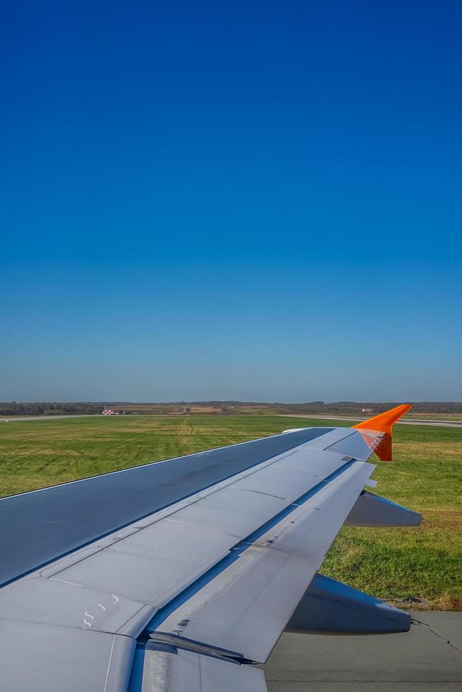 Airplane wing on the background of the landscape photo