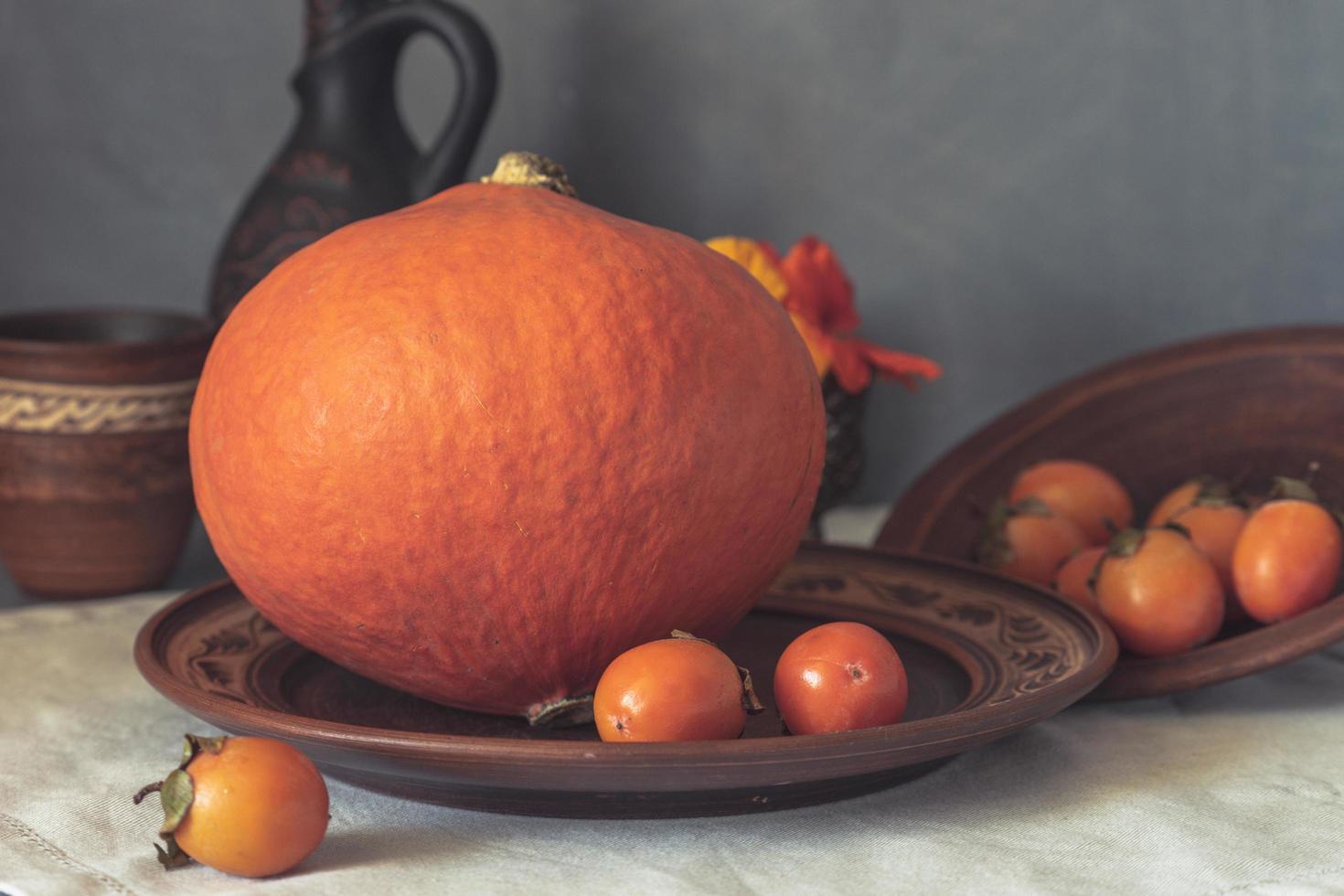 Autumn still life with pumpkin and nasturtium flowers. photo