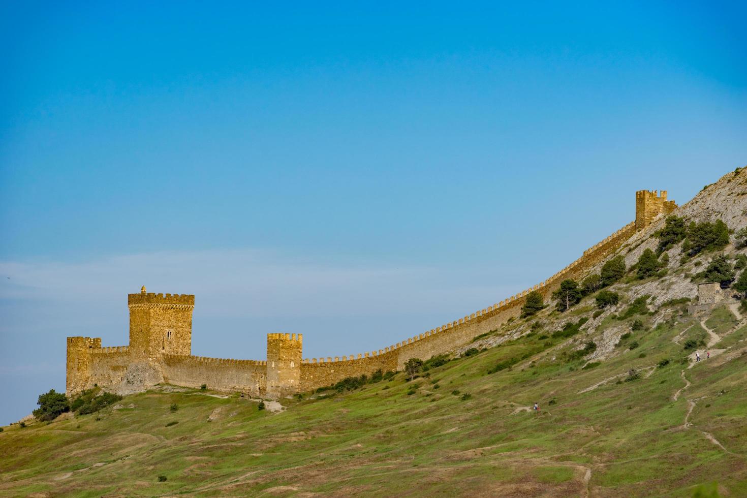 fortaleza genovesa en la cima de la montaña contra el cielo azul. foto