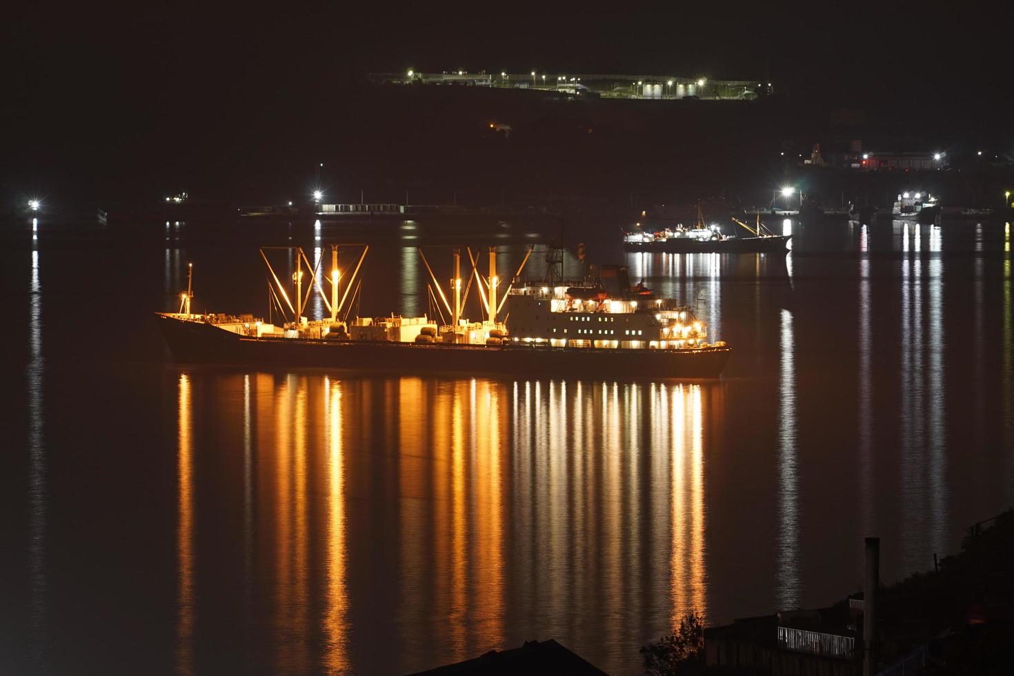 Ship with illumination against the sea. photo
