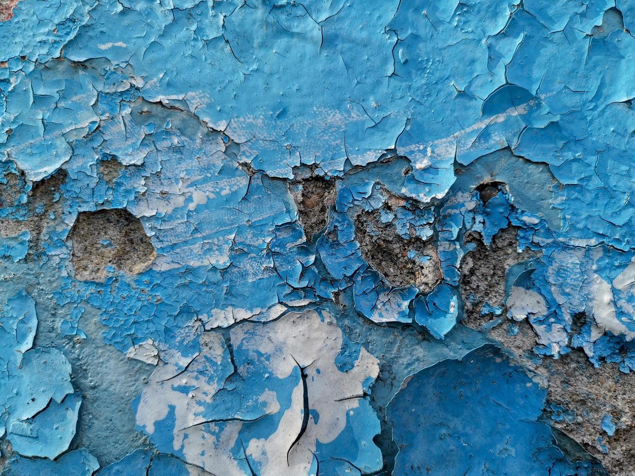 Blue background with cracked oil paint on plaster. photo