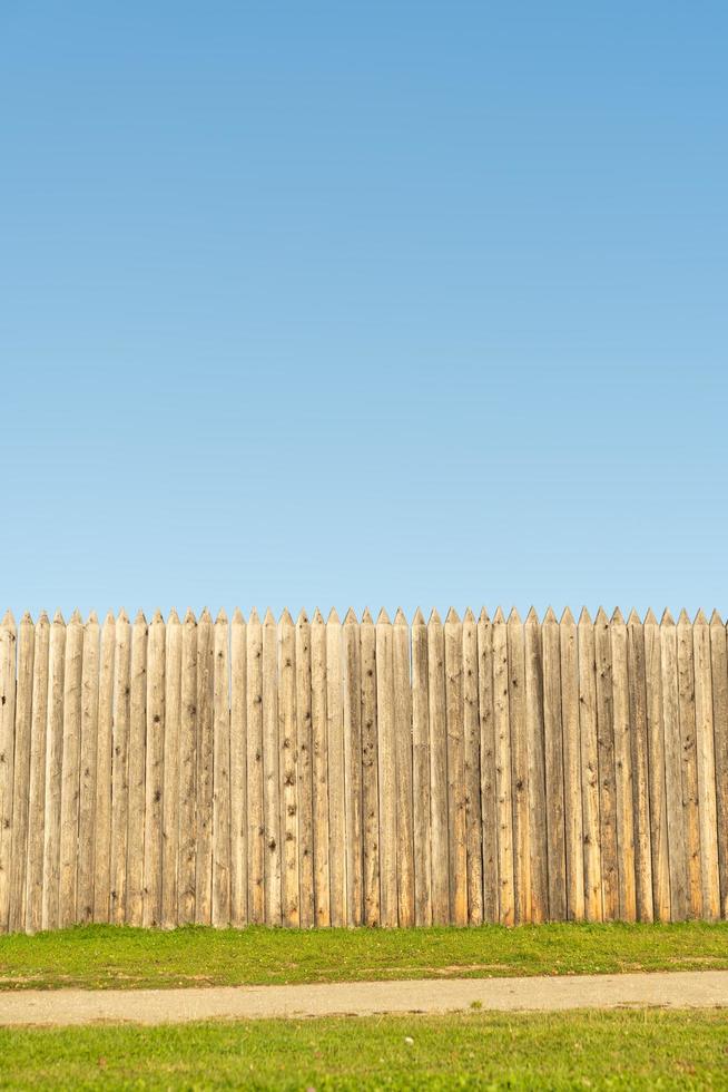 Wooden fence against the blue sky. photo