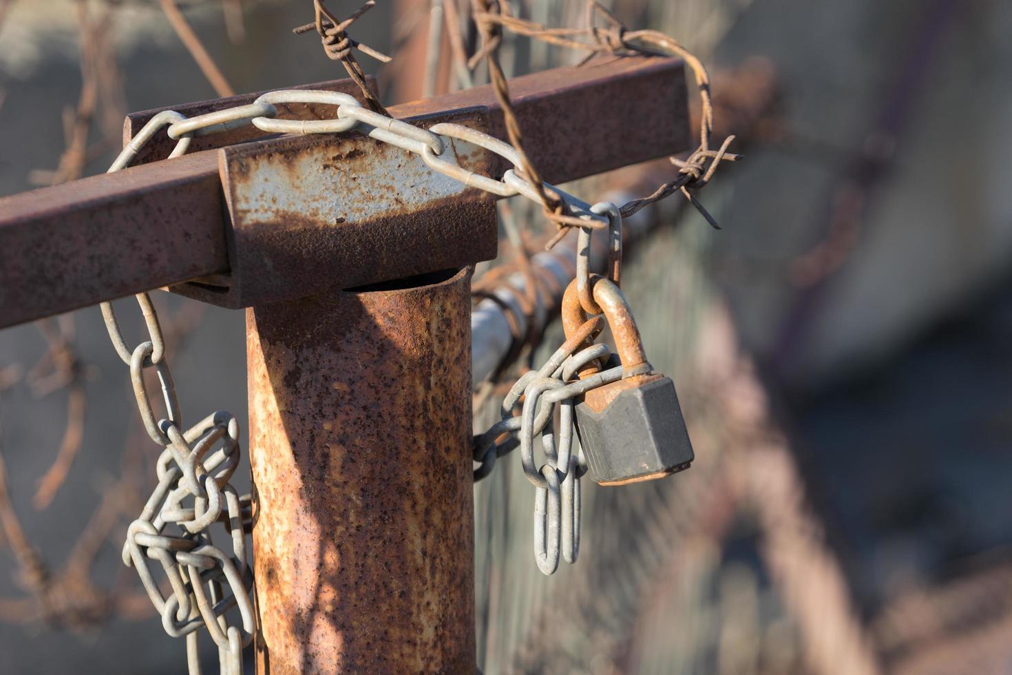 Blurred background with rusty metal wire and lock photo
