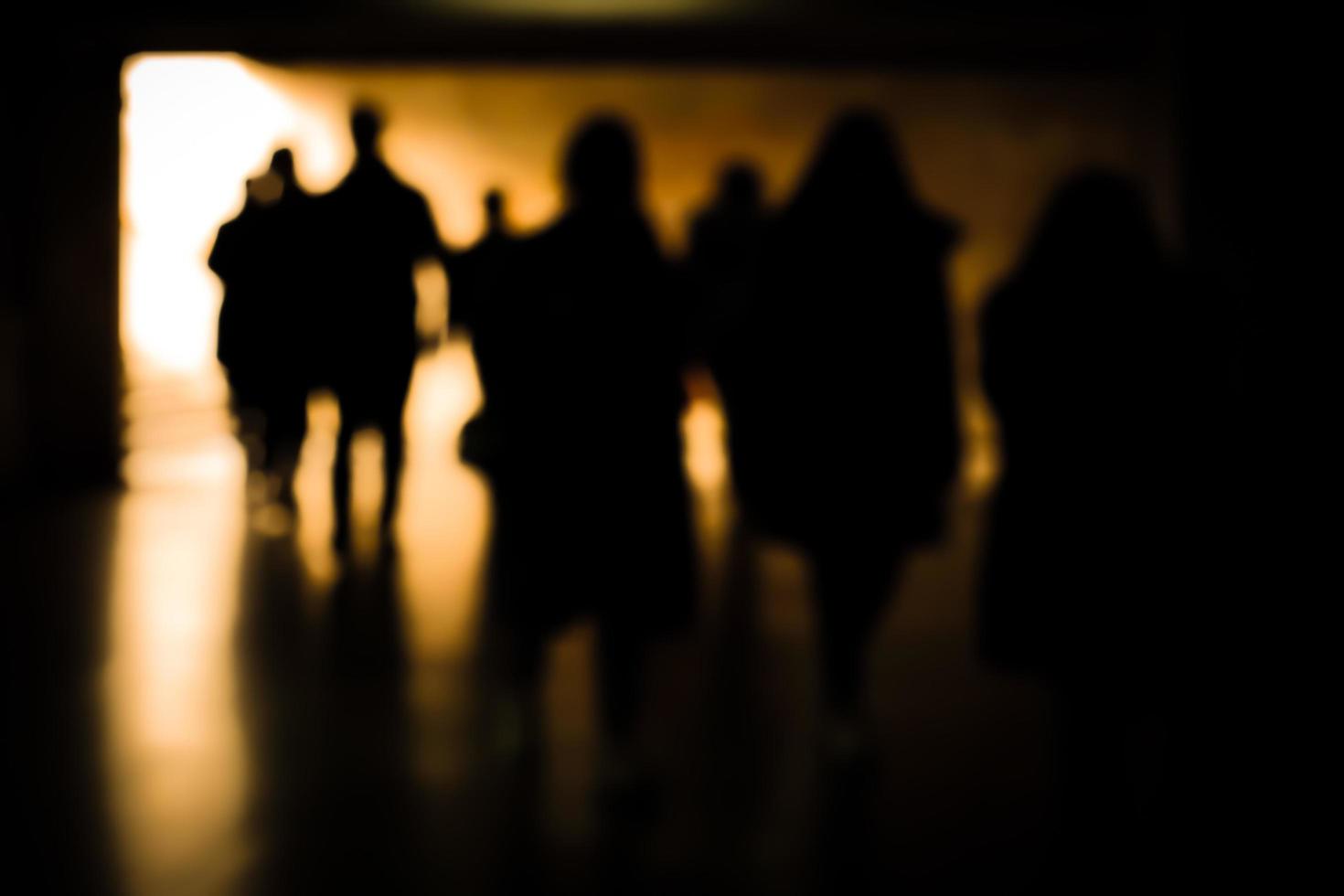 Blurry moving silhouettes in an underground passage. photo