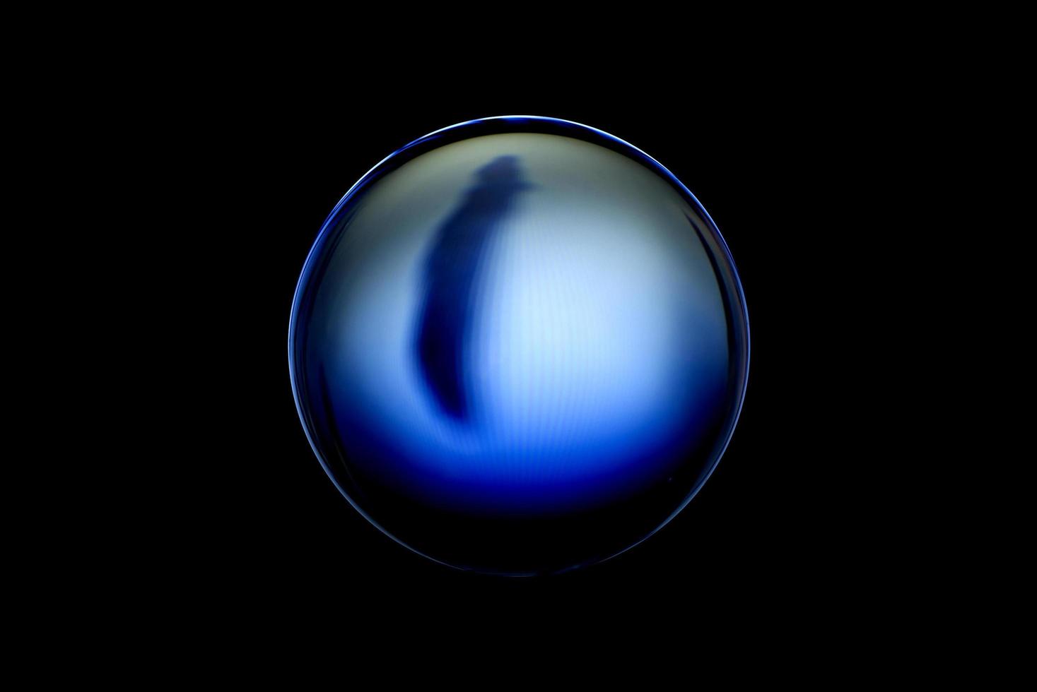 An abstract sphere with a blurry pattern isolated on black background. photo