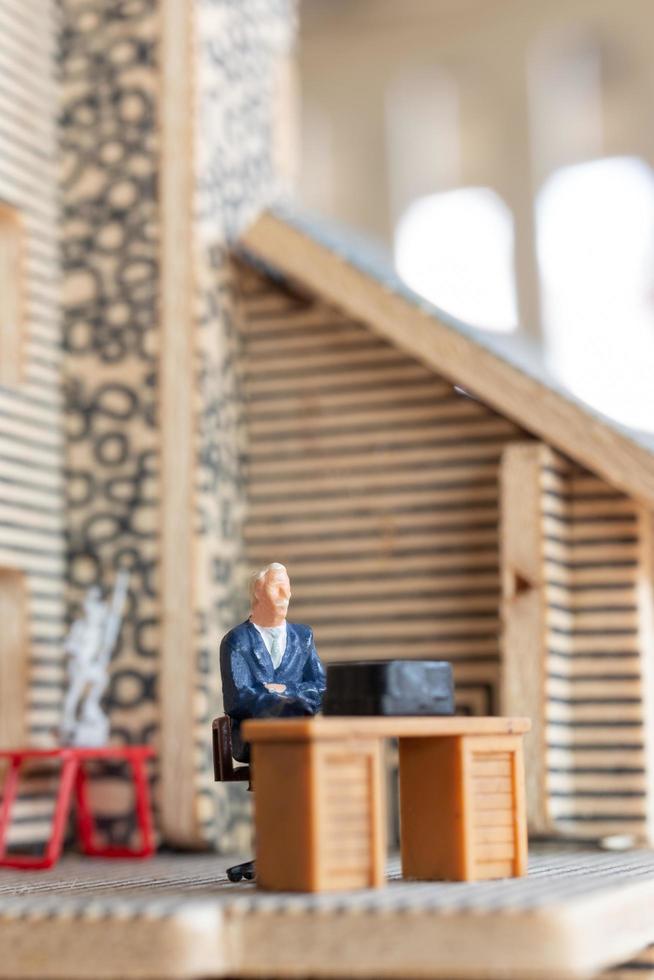 Miniature businesspeople working at home to protect themselves from coronavirus, work from home concept photo