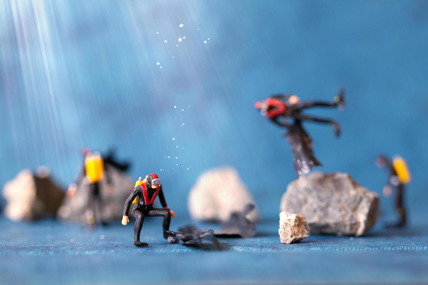 Miniature people, scuba divers clean up plastic rubbish pollution discarded in the ocean, underwater pollution concept photo