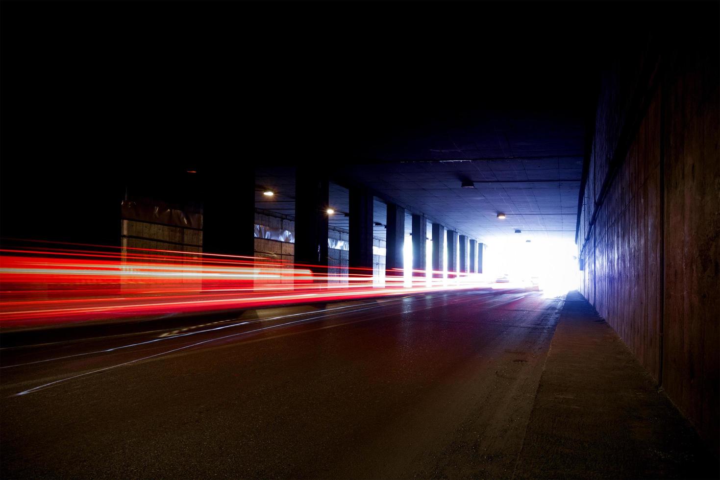 A dark tunnel with light trails photo