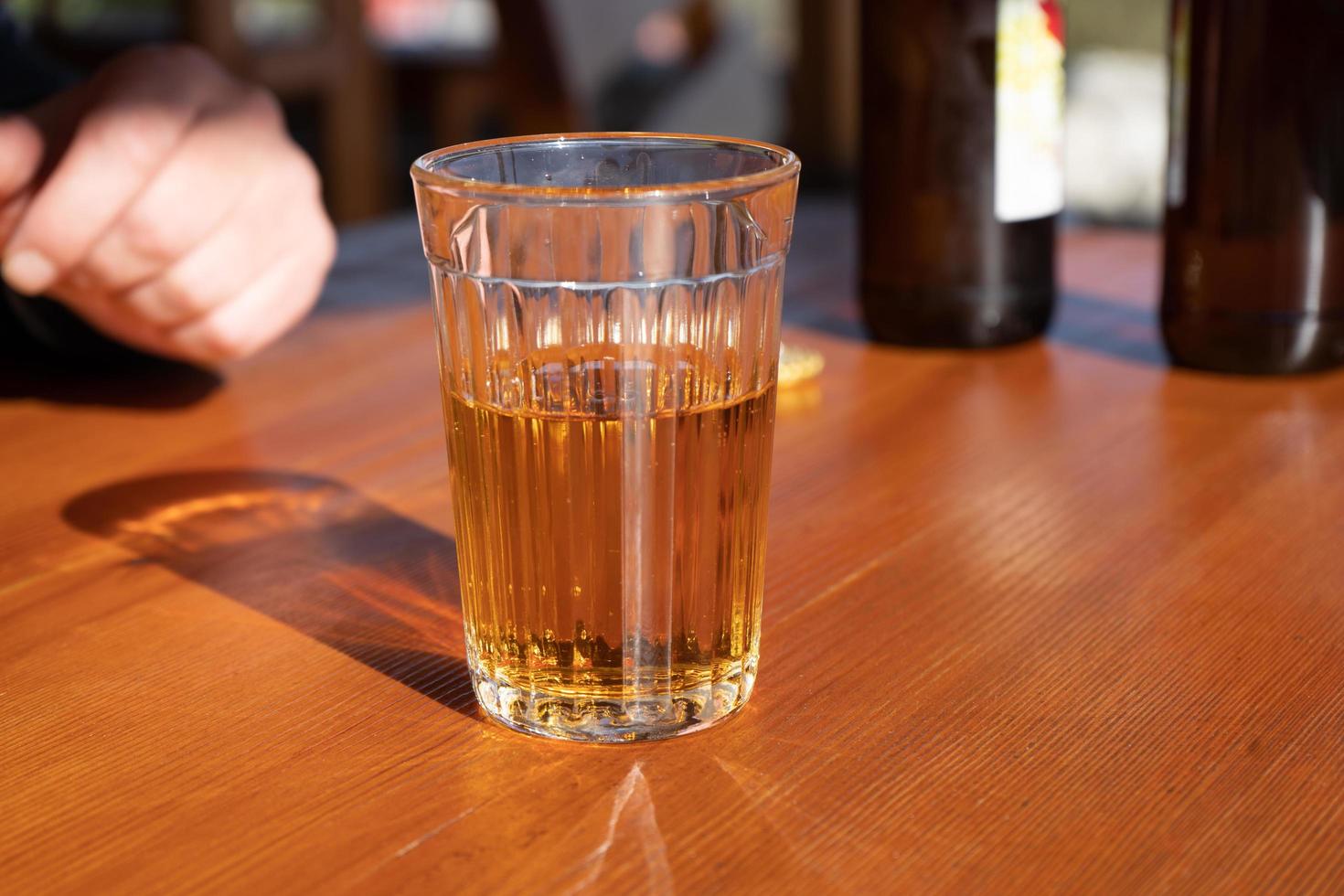 A glass of lemonade on the wooden surface of the table photo