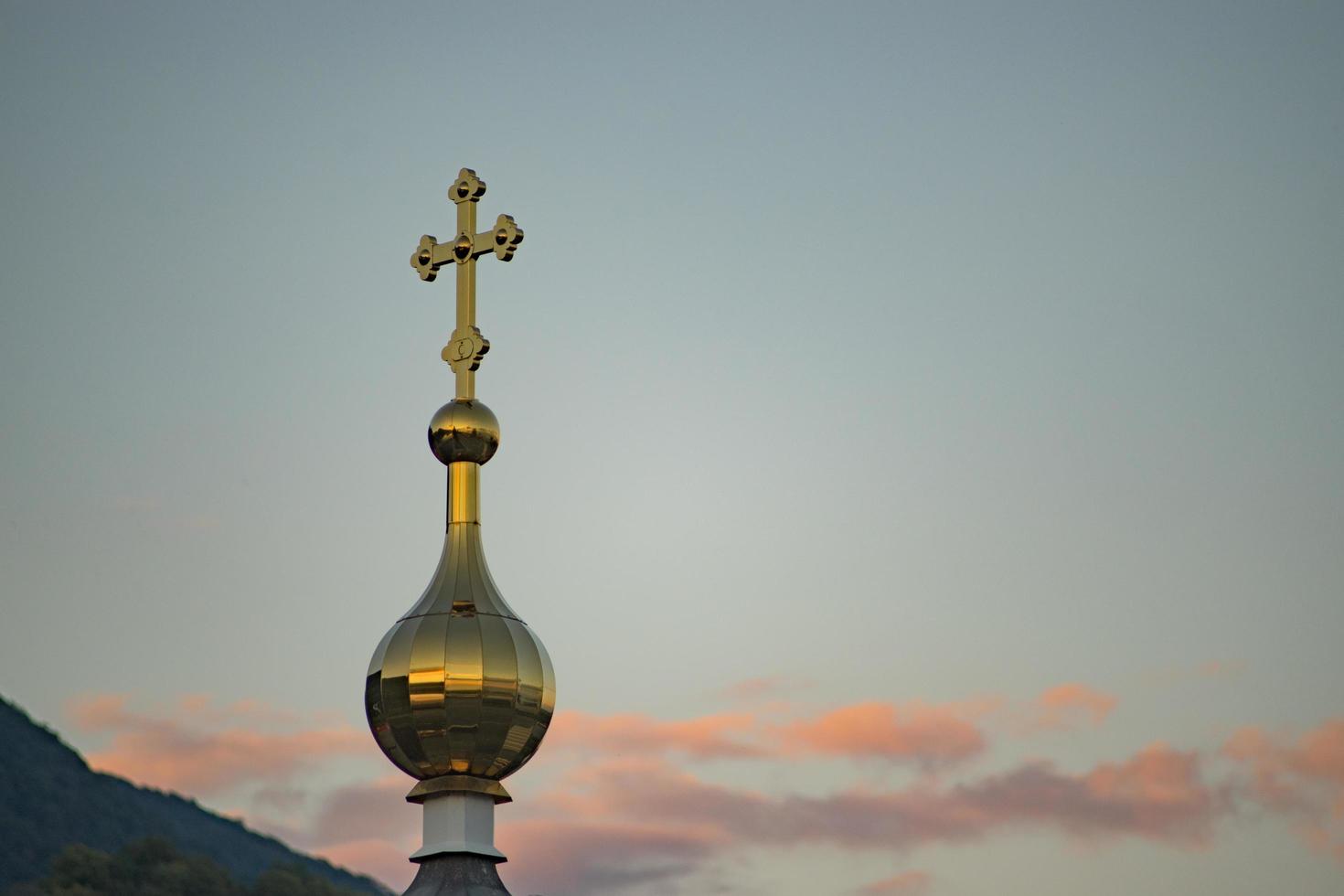 The golden dome of the chapel against the background of the evening sky photo