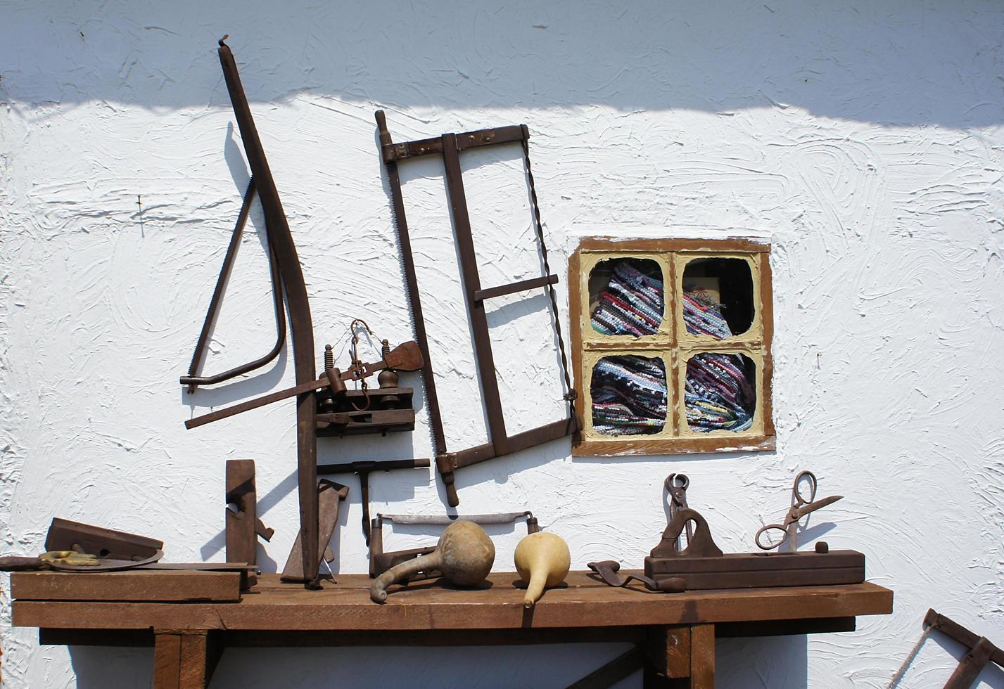 Vintage rusty tools on a white wall background photo