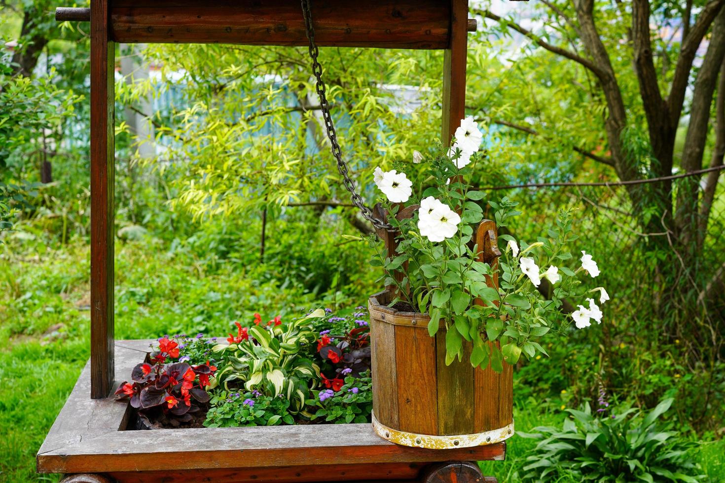 Rural landscape with flowers in a wooden bucket photo