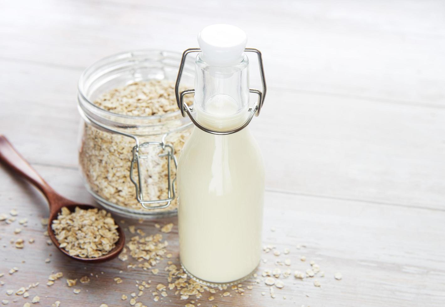 Vegan non-dairy alternative milk. Oat flakes milk photo