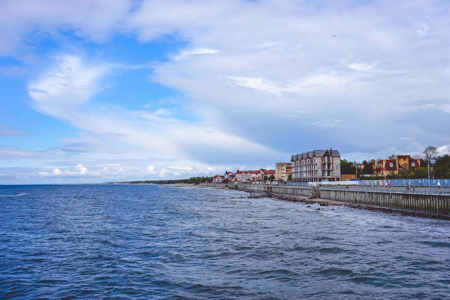 The sea with its long promenade and the historic resort town of Cranz. photo