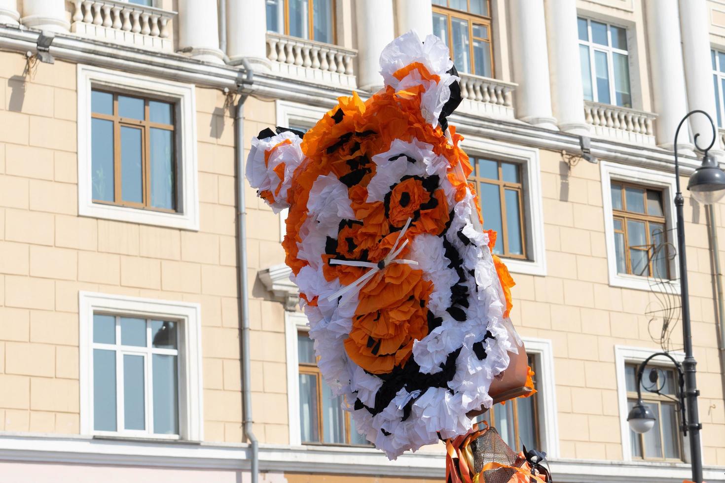 Tiger head made of paper on the background of the building. photo