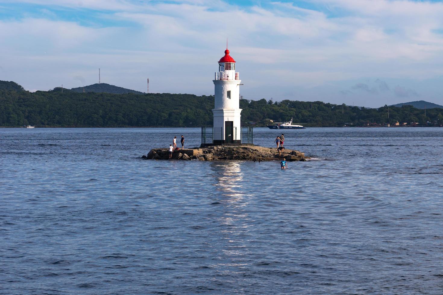 Seascape with a view of the lighthouse against the sea. photo