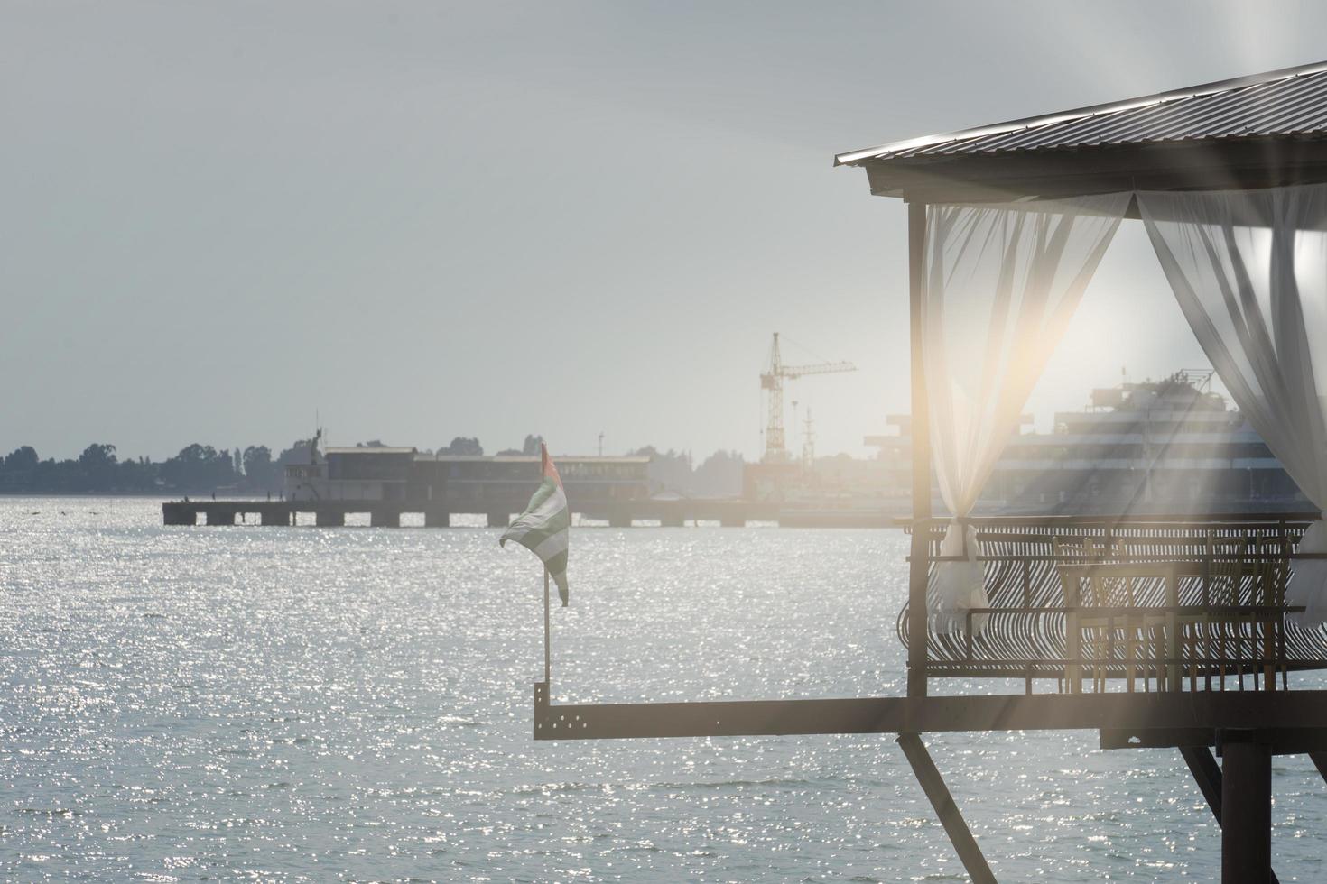 waterfront restaurant over the sea on the background of the old sea port of Sukhumi photo