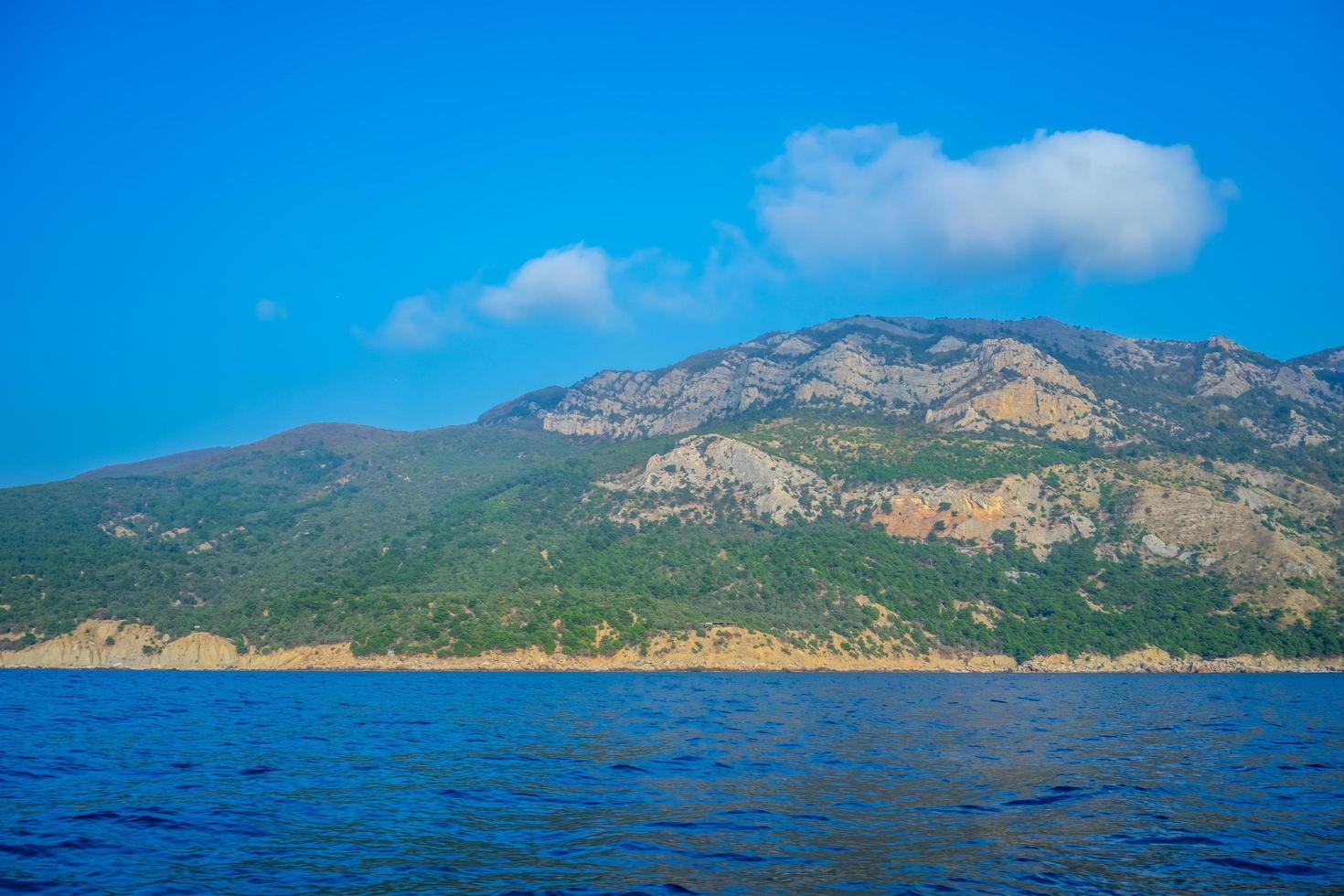 Seascape with views of the mountains near the coastline. photo