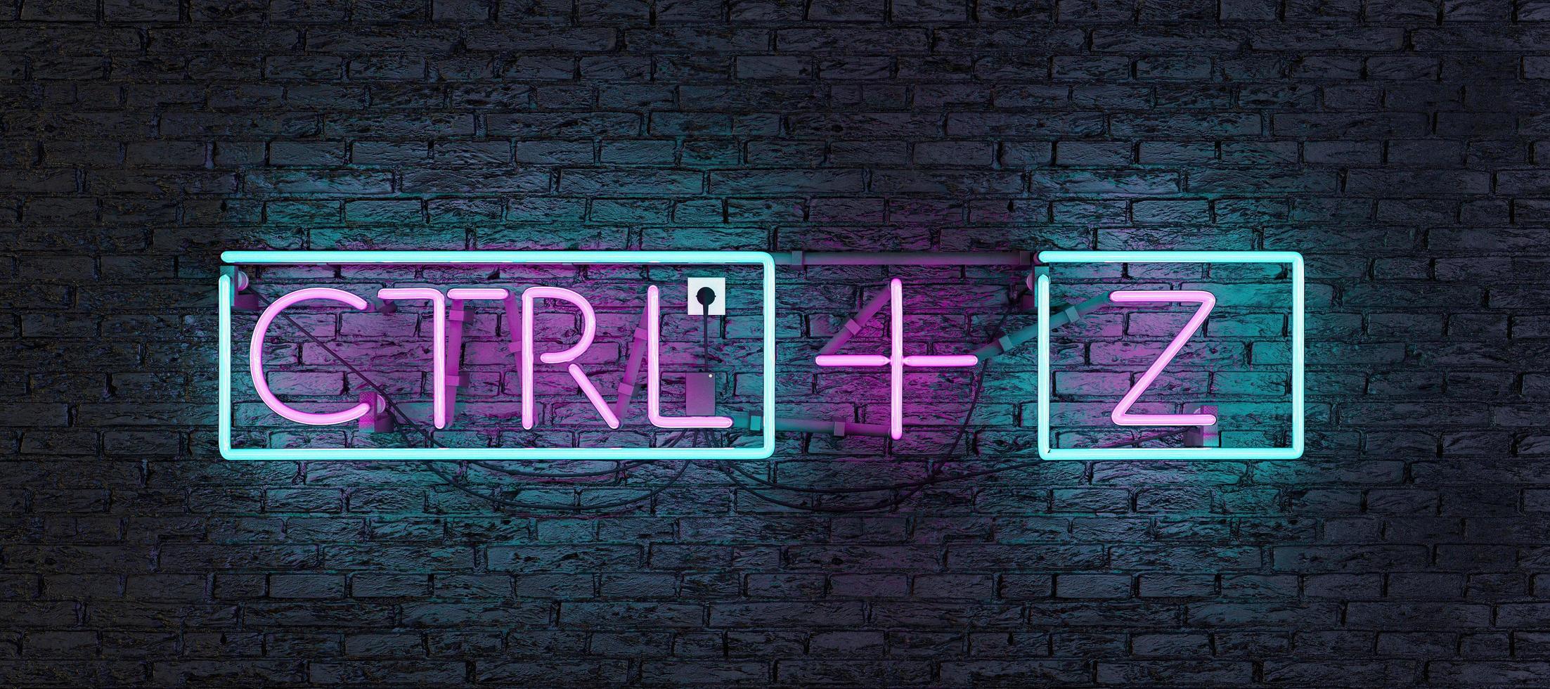 Neon with pink and blue light with CTRL plus Z sign on dark wall photo