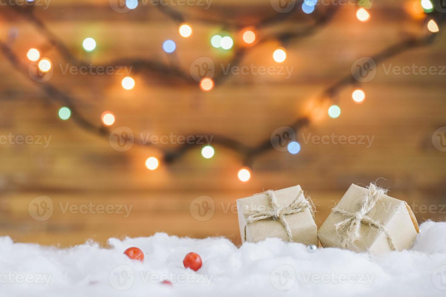 Present boxes on decorative snow near fairy lights photo
