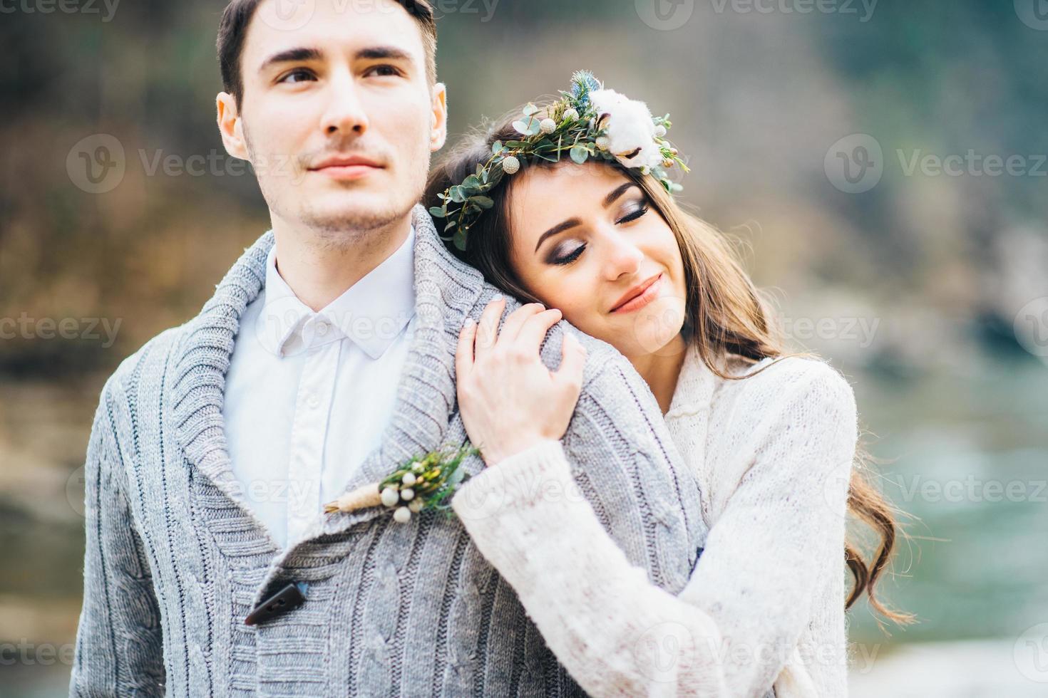 Young couple in love on a mountain river photo