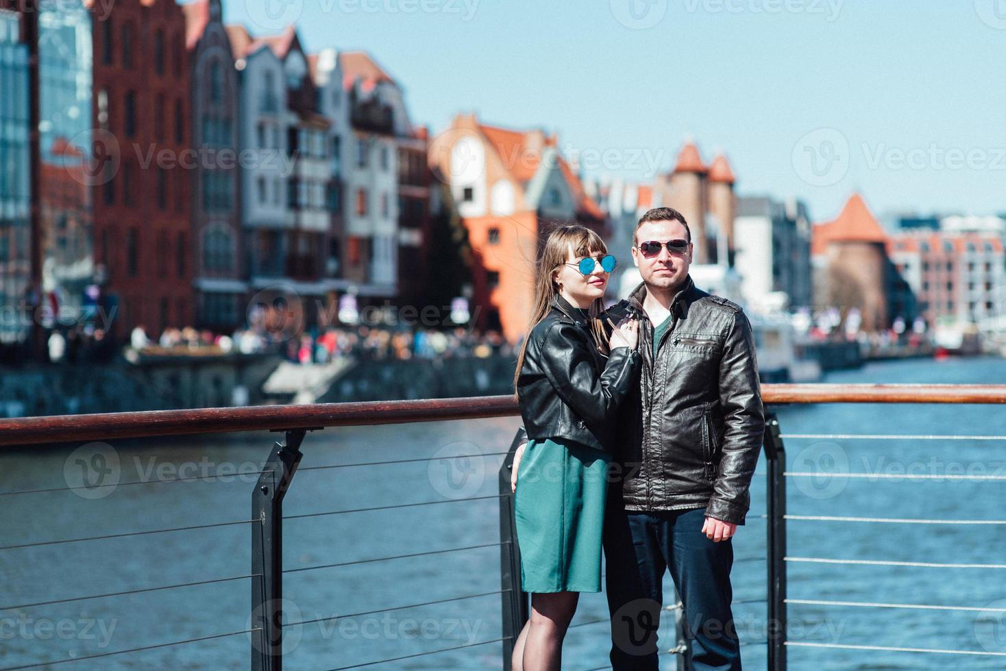 Happy guy and girl walking along the tourist streets of old Europe photo