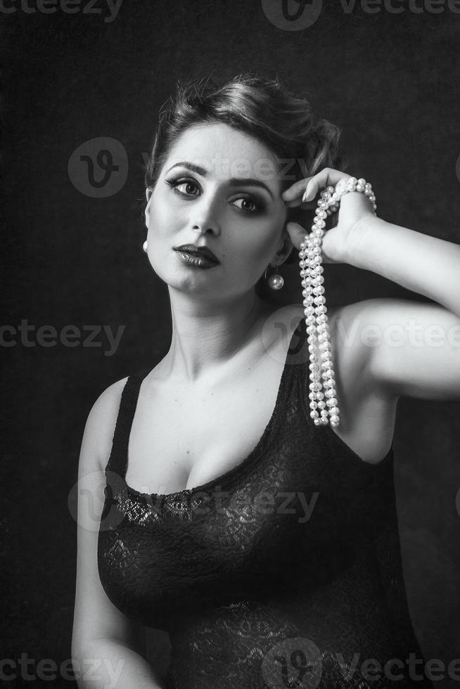 Young brunette model girl and actress in front of a mirror photo