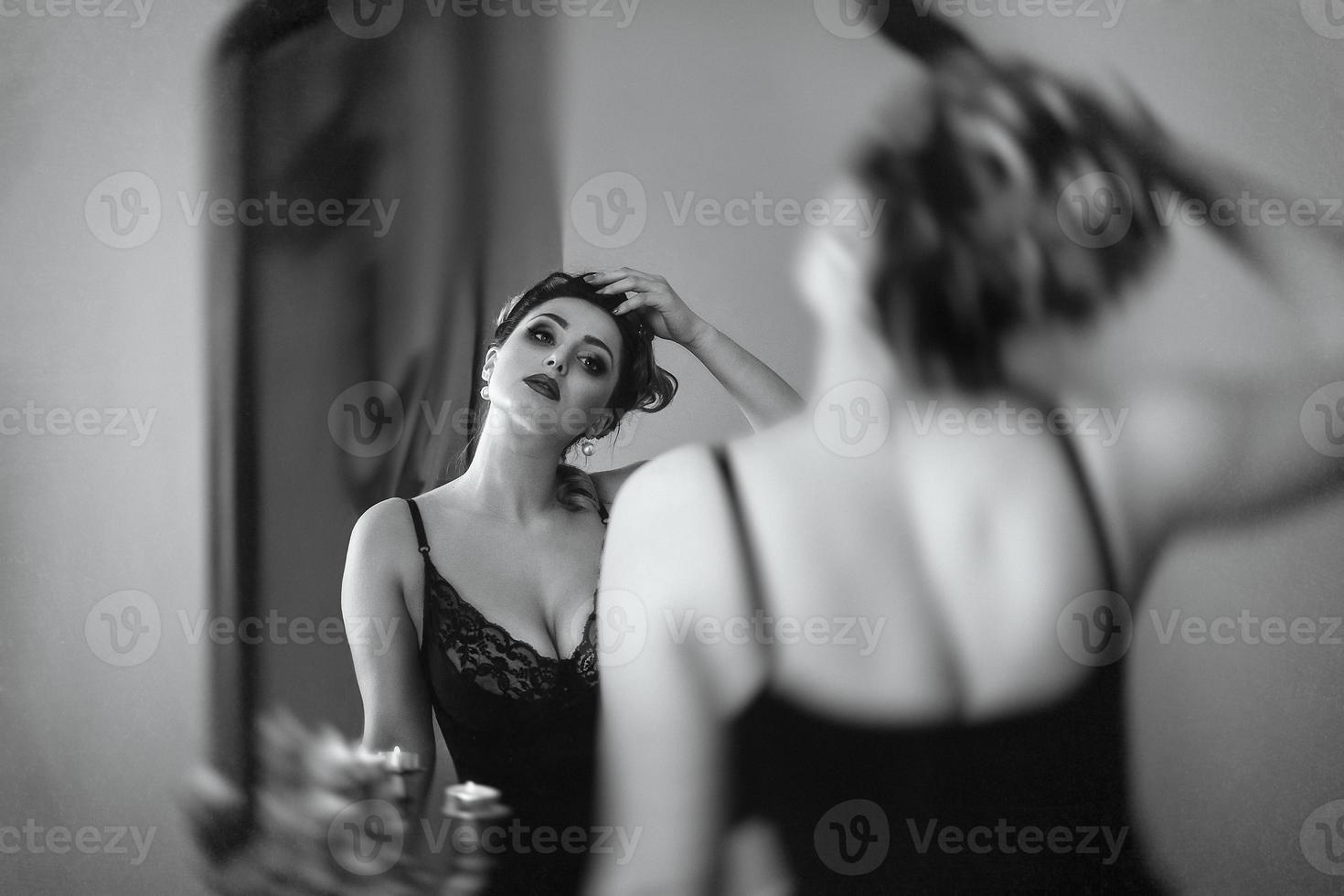 Young brunette model girl and actress in front of a mirror photo