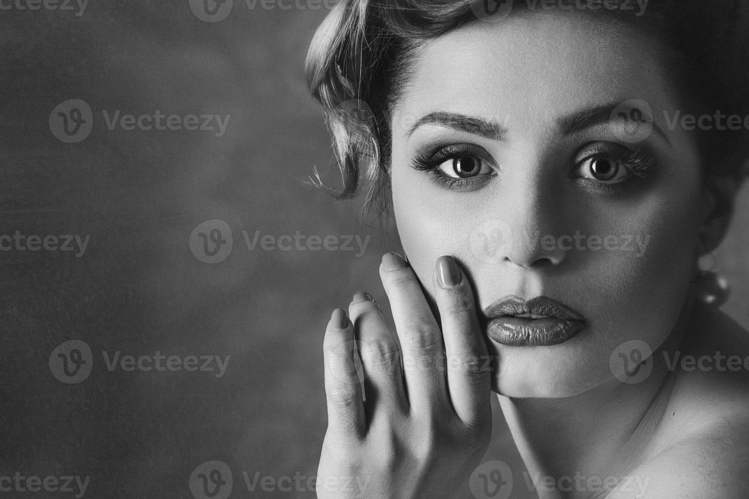 Young brunette model girl and actress in front of a mirror photo