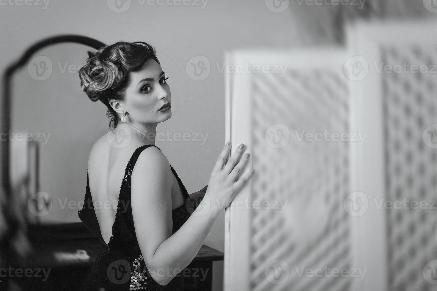 Young brunette model girl and actress in front of a mirror photo