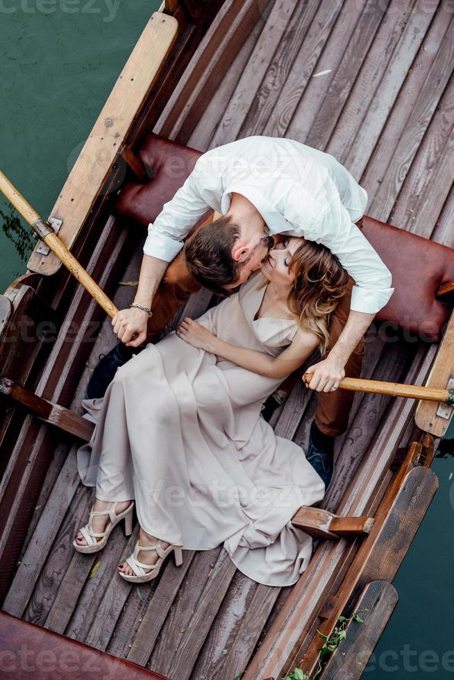 A boat trip for a guy and a girl along the canals and bays of the river photo