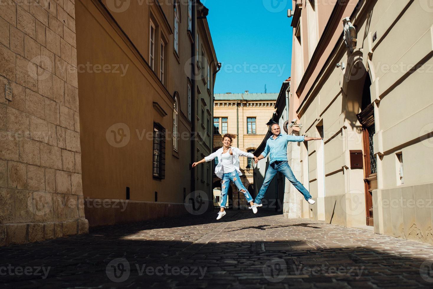 Guy and a girl happily walk in the morning on the empty streets photo