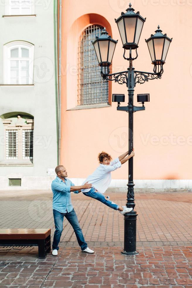 Guy and a girl happily walk in the morning on the empty streets photo