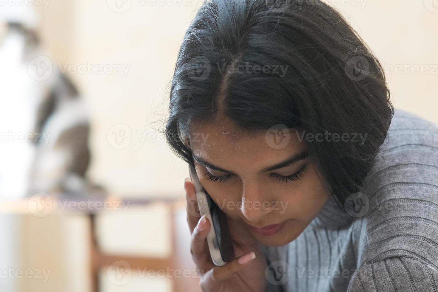 Beautiful brunette girl talking on mobile phone photo