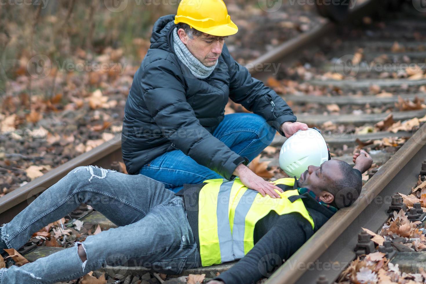 African American railroad engineer injured in an accident at work on the railway tracks photo