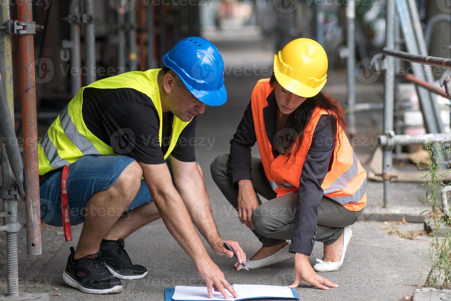 Male and female construction workers photo