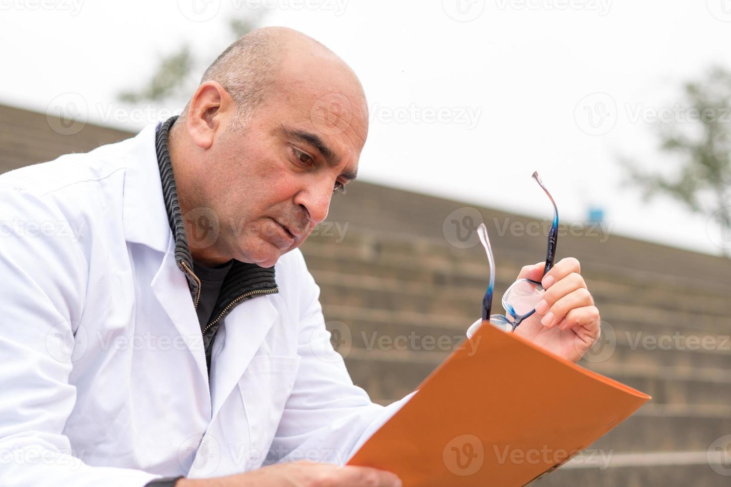 Doctor reading medical reports photo