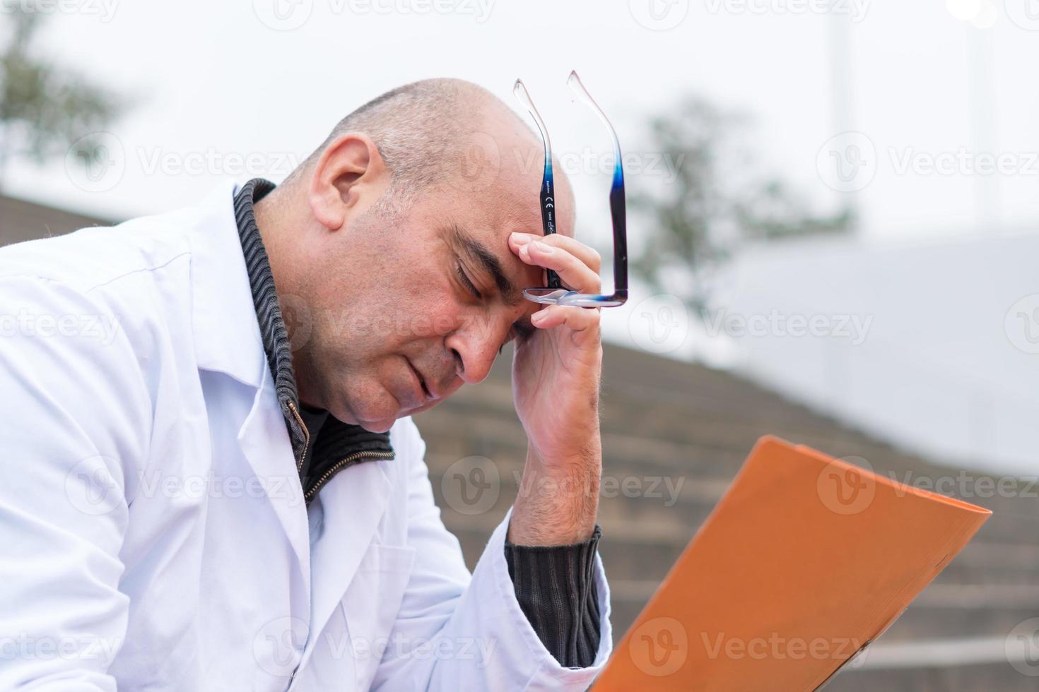 Doctor reading bad reports photo