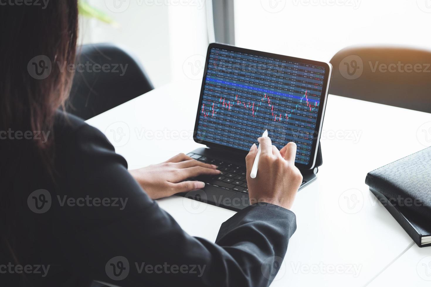 Stock market trader looking at trading charts photo