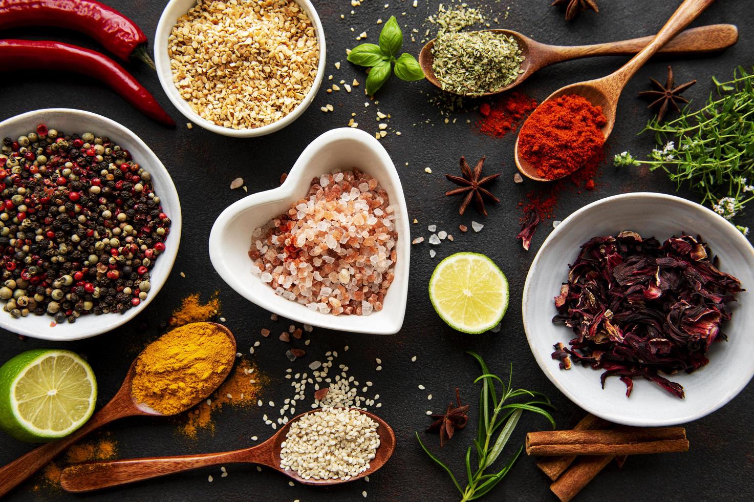 Colorful and aromatic herbs and spices on a dark background photo