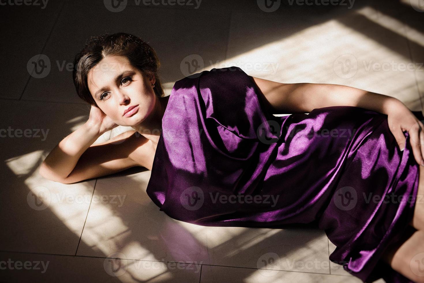 model girl in a blue dress in an art workshop with brushes photo