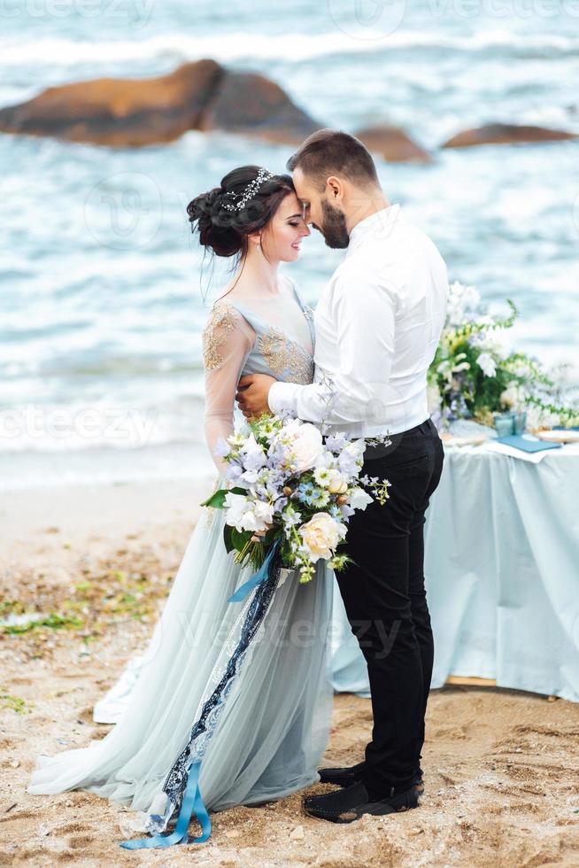 same couple with a bride in a blue dress walk photo