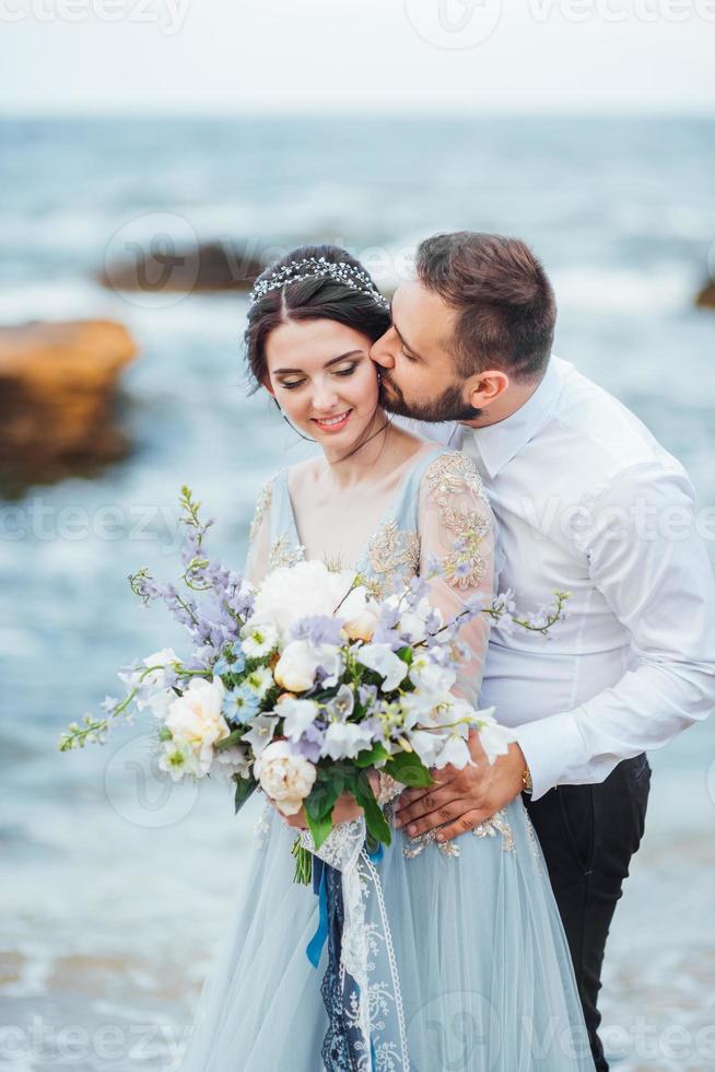 same couple with a bride in a blue dress walk photo