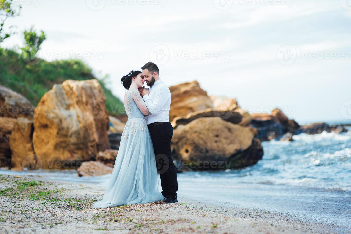 misma pareja con una novia con un vestido azul a pie foto