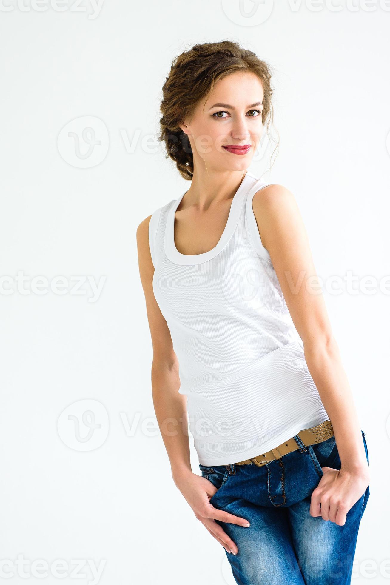 Cheerful Girl In A White Tshirt And Dark Blue Jeans In The Studio On A White Background Stock Photo At Vecteezy Cheerful Girl In A White Tshirt And Dark Blue Jeans In The Studio On A White Background Stock Photo At Vecteezy