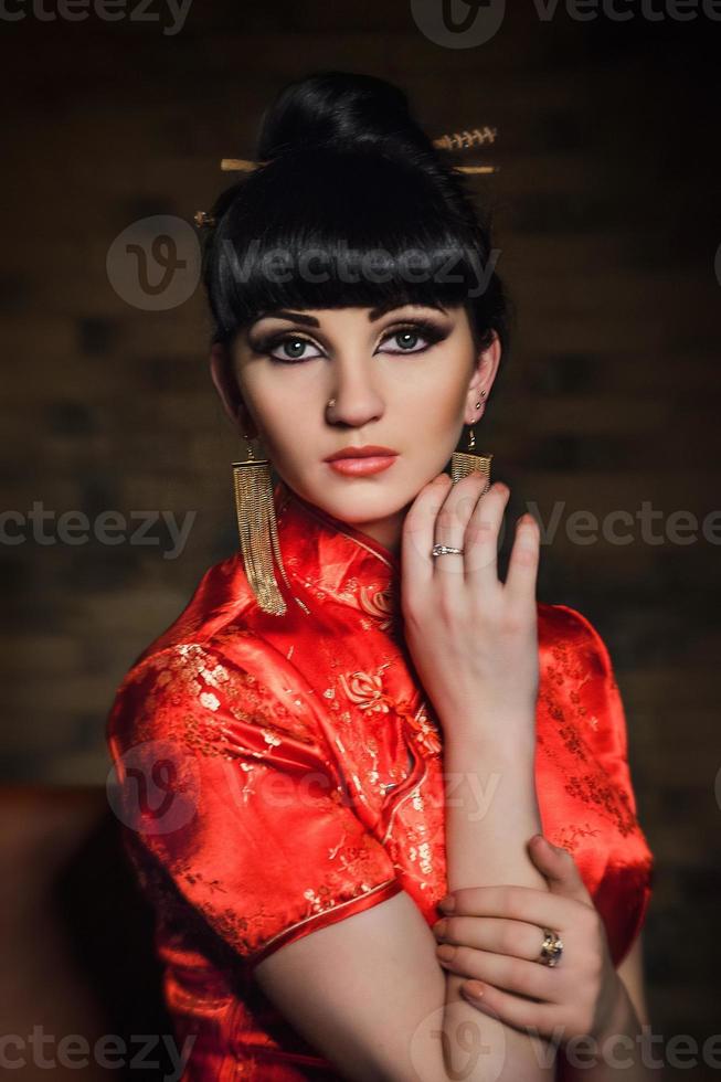 girl in a red Japanese silk dress qipao in a dark room 2376240 Stock