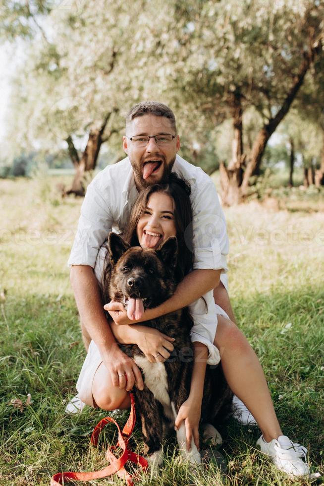 Big dog for a walk with a guy and a girl photo