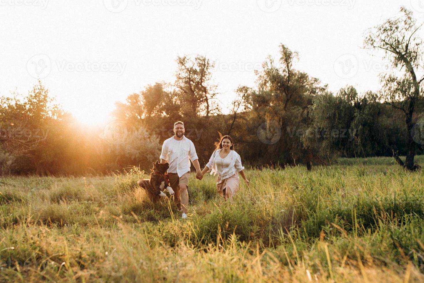 Big dog for a walk with a guy and a girl photo