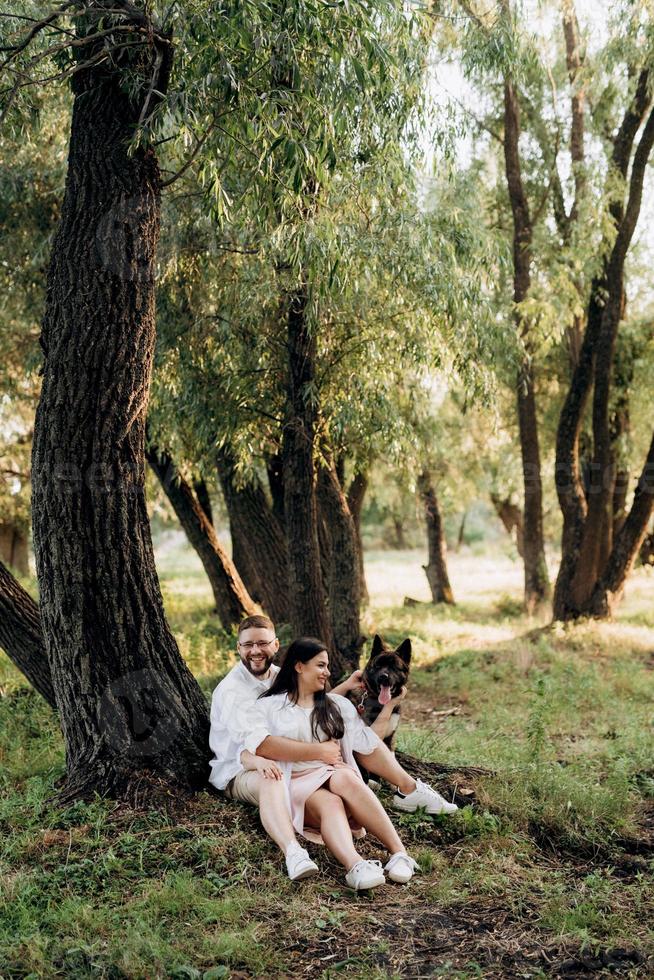 Big dog for a walk with a guy and a girl photo