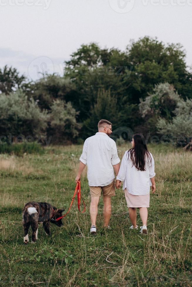 Big dog for a walk with a guy and a girl photo